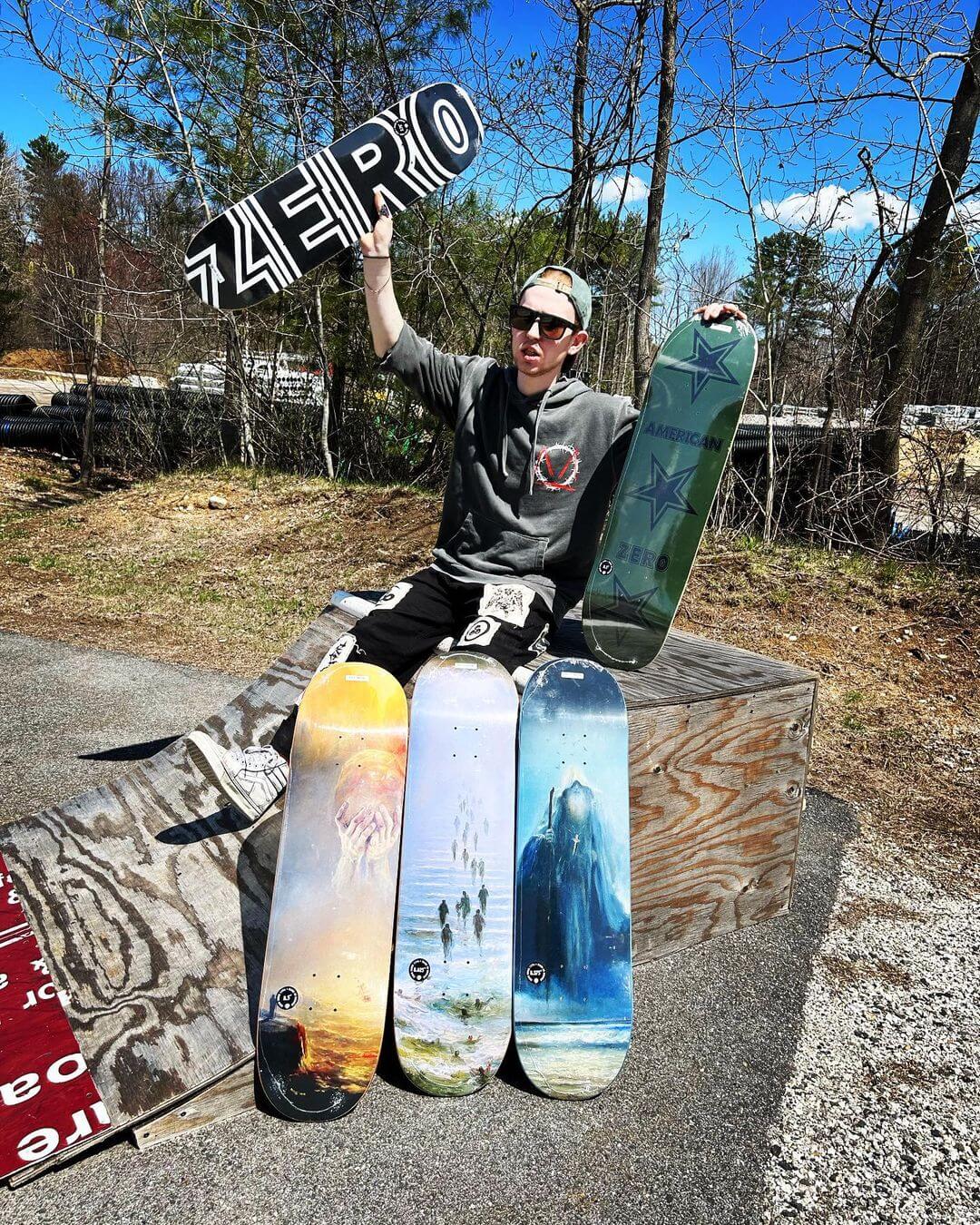employee holding skateboard decks at Backwoods Snow and Skate Auburn Maine